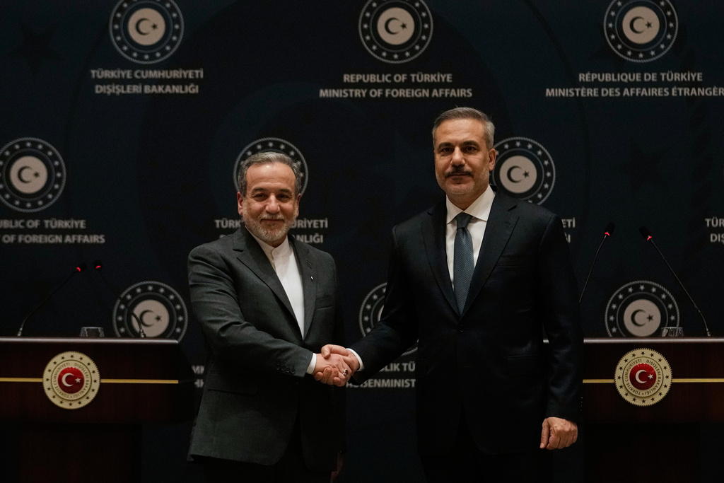 Turkish Foreign Minister Hakan Fidan, right, shakes hands with his Iranian counterpart Abbas Araghchi following a joint press conference in Istanbul, Turkey, Friday, Jan. 30, 2026. (AP Photo/Khalil Hamra)