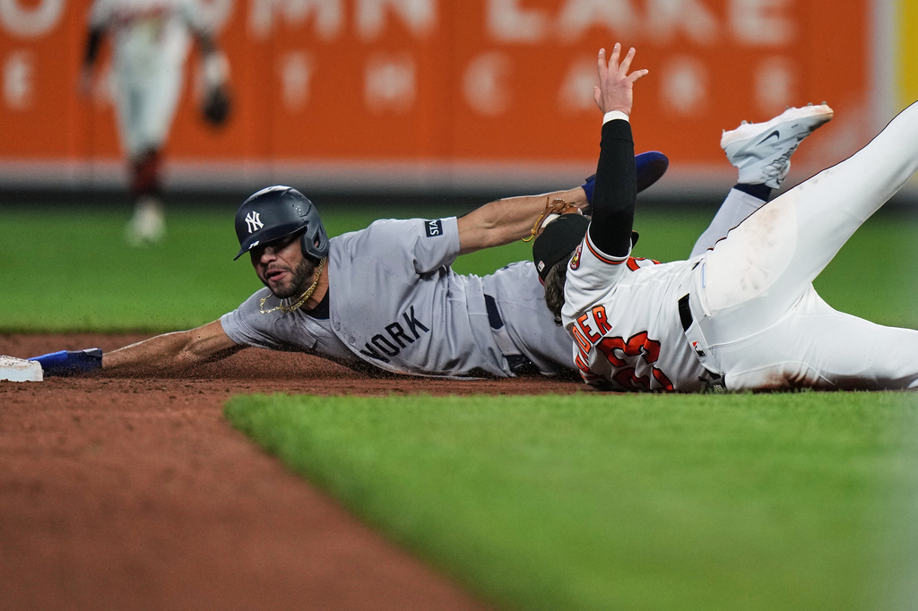New York Yankees' José Caballero, left, is caught by Baltimore Orioles second baseman Blaze Alexander, right, while trying to steal second base during the ninth inning of a baseball game, Monday, May 11, 2026, in Baltimore. (AP Photo/Stephanie Scarbrough)
