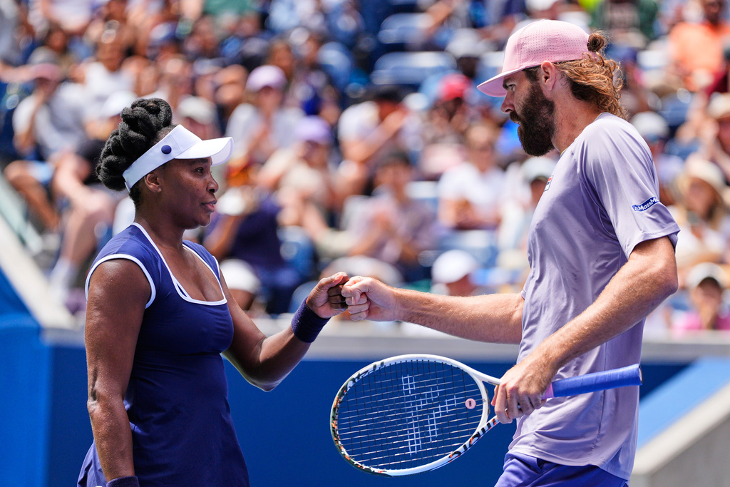 Venus Williams fist bumps her partner Reilly Opelka during the mixed doubles competition of the U.S. Open tennis tournament in New York, Tuesday, Aug. 19, 2025. (AP Photo/Yuki Iwamura)