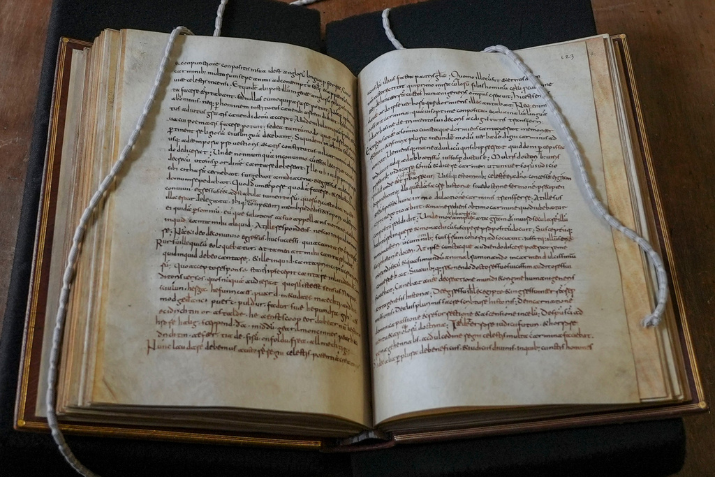 A rare, long-lost copy of Caedmon's Hymn — the first poem ever written down in Old English — is visible in the five lines above the final line of the left page from an 8th-century manuscript copy of the Venerable Bede's Ecclesiastical History of the English People, at Rome's National Library, Thursday, May 8, 2026. (AP Photo/Andrea Rosa)null