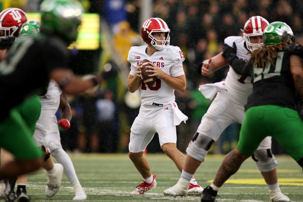 Indiana quarterback Fernando Mendoza (15) looks for an opening in the Oregon defense during the second half of an NCAA college football game, Saturday, Oct. 11, 2025, in Eugene, Ore. (AP Photo/Lydia Ely)