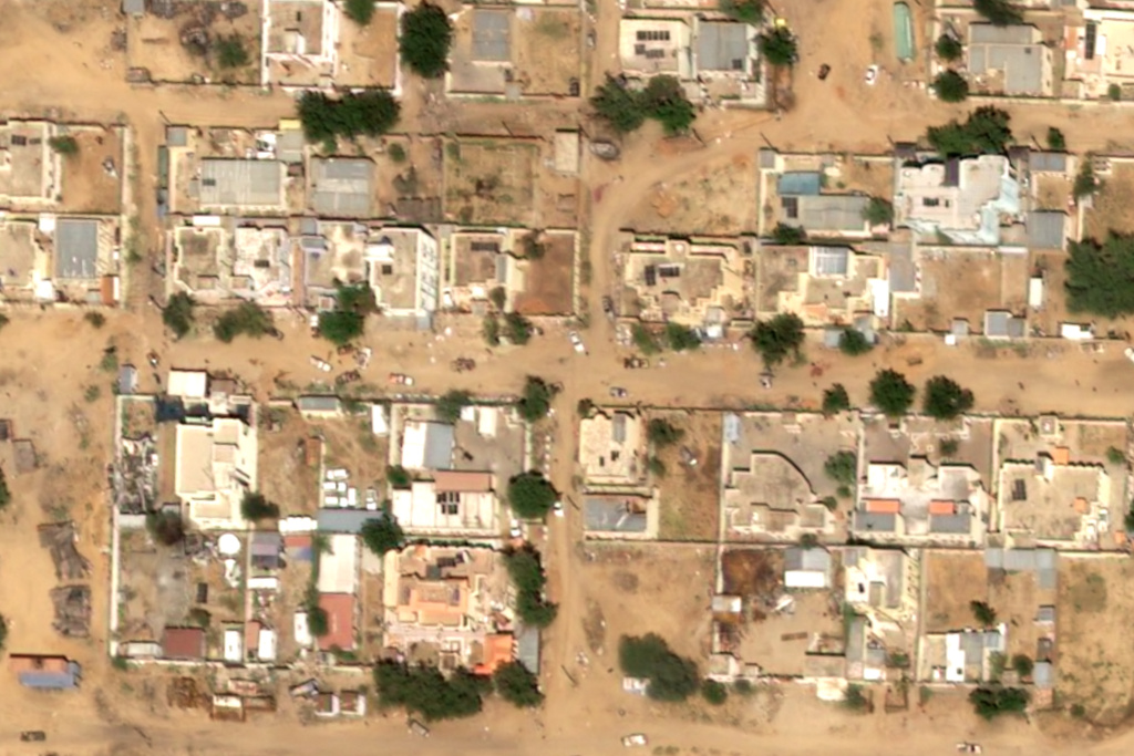 This satellite image taken by Airbus DS shows two reddish stains on the ground near what are likely Rapid Support Forces vehicles in the Daraja Oula neighborhood of el-Fasher, Sudan, Monday, Oct. 27, 2025. (Airbus DS 2025 via AP)