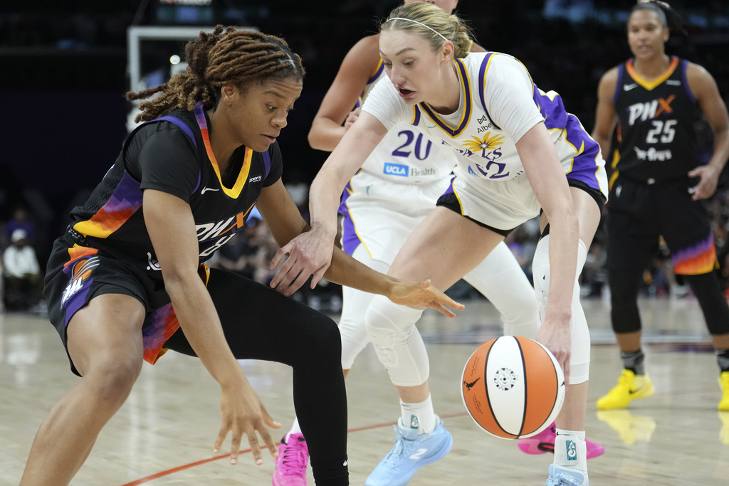 Los Angeles Sparks forward Cameron Brink, right, strips the ball away from Phoenix Mercury guard Monique Akoa Makani (8) during the first half of a WNBA basketball game Tuesday, Sept. 9, 2025, in Phoenix. (AP Photo/Ross D. Franklin)