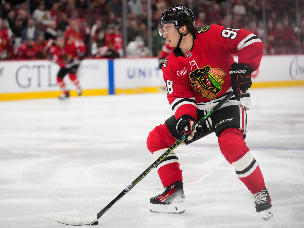 Chicago Blackhawks center Connor Bedard handles the puck during the third period of an NHL hockey game against the Calgary Flames, Thursday, Jan. 15, 2026, in Chicago. (AP Photo/Erin Hooley)