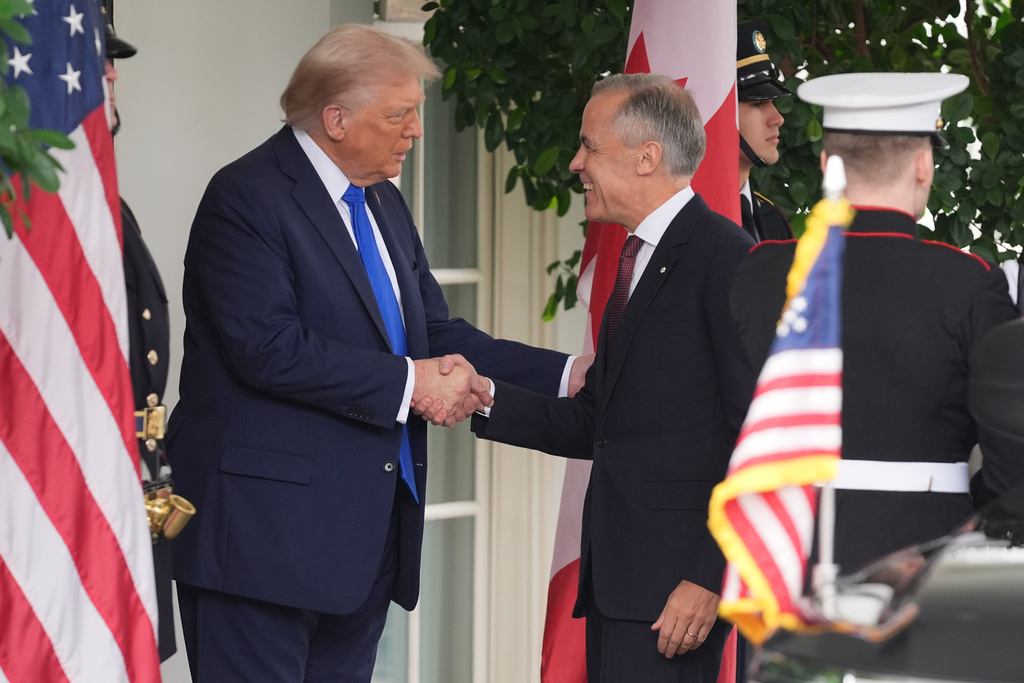 President Donald Trump greets Canadian Prime Minister Mark Carney at the White House, Tuesday, Oct. 7, 2025, in Washington. (AP Photo/Evan Vucci)