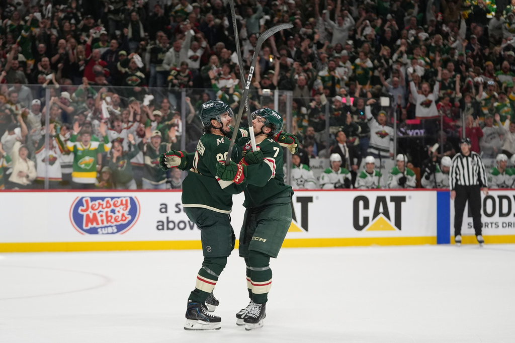 Minnesota Wild left wing Marcus Johansson (90), left, celebrates with defenseman Brock Faber (7) after scoring a goal during the first period of Game 3 in the first-round of the NHL Stanley Cup hockey playoffs against the Dallas Stars Wednesday, April 22, 2026, in St. Paul, Minn. (AP Photo/Abbie Parr)