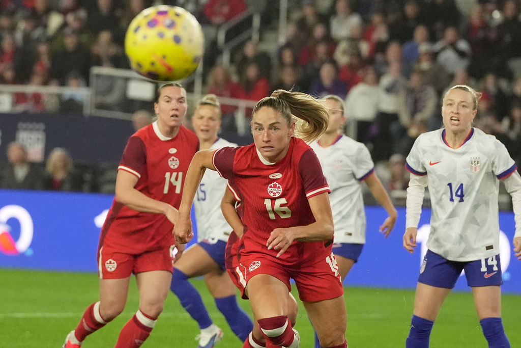 Canada midfielder Janine Sonis (16) chases after the ball in front of United States' Emily Sonnett (14) in the first half of a SheBelieves Cup women's soccer match in Columbus, Ohio, Wednesday, March 4, 2026. (AP Photo/Sue Ogrocki)