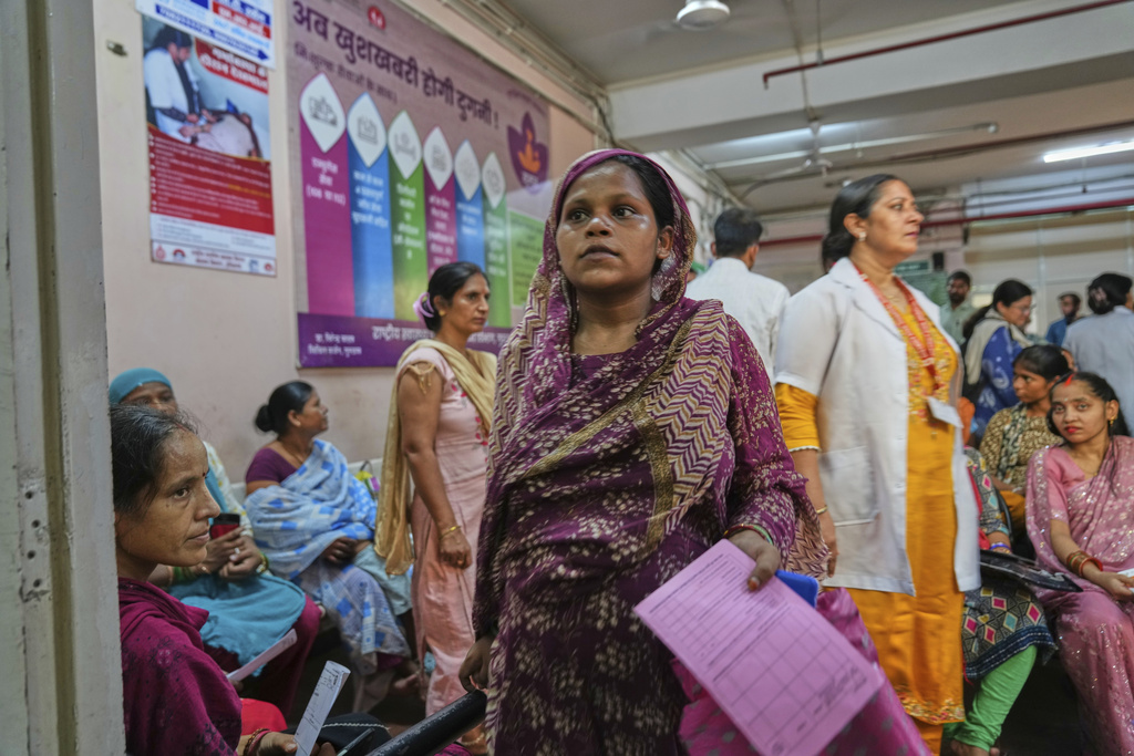 A pregnant woman walks for her routine check after attending an antenatal Care Companion Program (CCP) at a government hospital in Gurugram, a satellite city of New Delhi, India, on Aug. 7, 2025. (AP Photo/Manish Swarup)