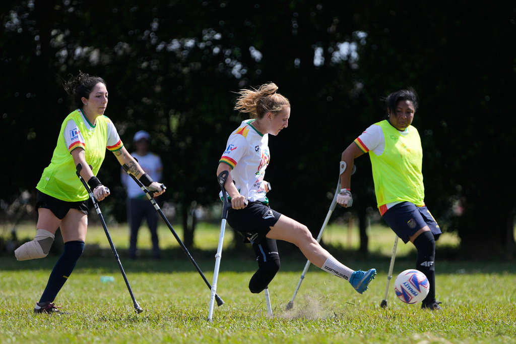 Players vie for the ball during a women's amputee soccer clinic in Santa Cruz, Bolivia, Friday, July 17, 2026. (AP Photo/Juan Karita)