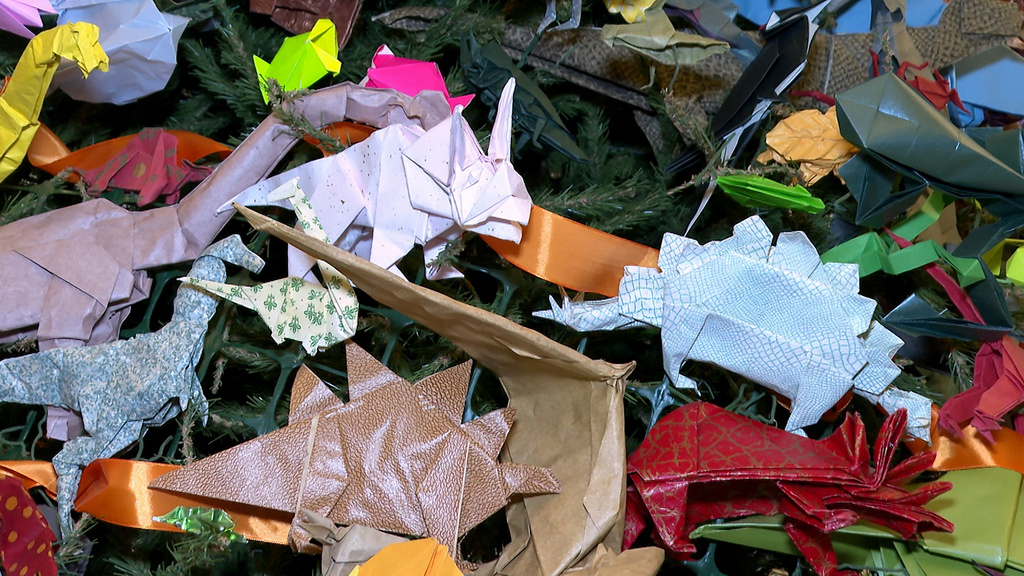Colorful origami dinosaurs decorate the Origami Holiday Tree at the American Museum of Natural History Thursday, Nov. 13, 2025, in New York. (AP Photo/Joe Frederick)