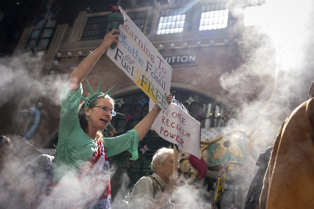 A woman dressed as the Statue of Liberty marches through Manhattan in the "Make Billionaires Pay" climate protest, Saturday, Sept. 20, 2025, in New York. (AP Photo/Angelina Katsanis)