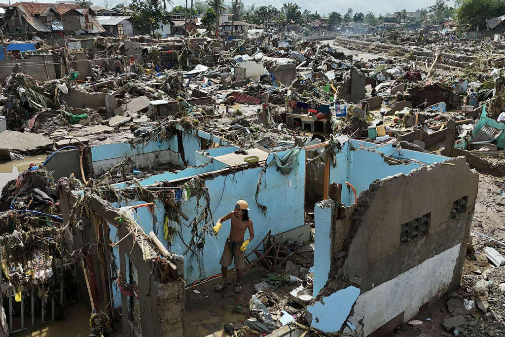 A resident returns to what remains of their home after Typhoon Kalmaegi devastated communities along the Mananga River in Talisay City, Cebu province, central Philippines, Wednesday, Nov. 5, 2025. (AP Photo/Jacqueline Hernandez)