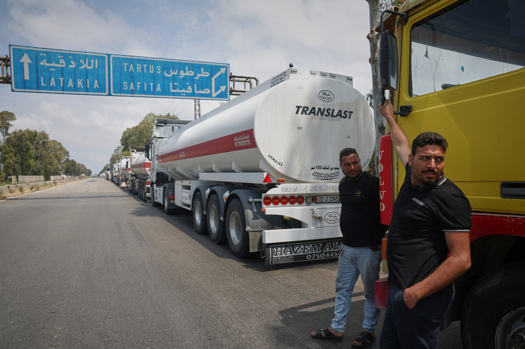Iraqi trucks loaded with oil wait to drive toward the Baniyas oil refinery along a highway in Tartus Governorate, western Syria, Friday, May 1, 2026. (AP Photo/Ghaith Alsayed)