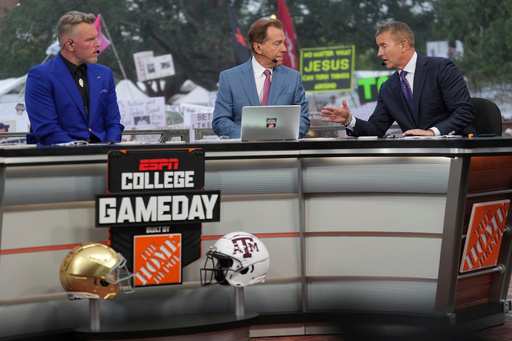 FILE - From left, Pat Mcafee, Nick Saban and Kirk Herbstreit talk on the set of ESPN College Gameday on Saturday, Aug. 31, 2024, in College Station, Texas. (AP Photo/Sam Craft, File) FILE - From left, Pat Mcafee, Nick Saban and Kirk Herbstreit talk on the set of ESPN College Gameday on Saturday, Aug. 31, 2024, in College Station, Texas. (AP Photo/Sam Craft, File)