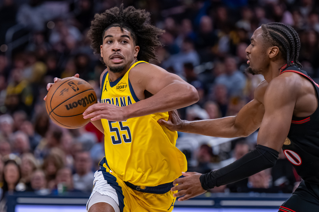 Indiana Pacers guard Ethan Thompson (55) drives toward the basket while being defended Philadelphia 76ers guard Tyrese Maxey (0) during the second half of an NBA basketball game in Indianapolis, Friday, April 10, 2026. (AP Photo/Doug McSchooler)