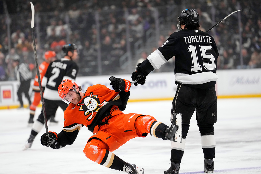 Anaheim Ducks center Jansen Harkins, left, is shoved to the ice by Los Angeles Kings center Alex Turcotte during the first period of an NHL hockey game Friday, Jan. 16, 2026, in Los Angeles. (AP Photo/Mark J. Terrill)