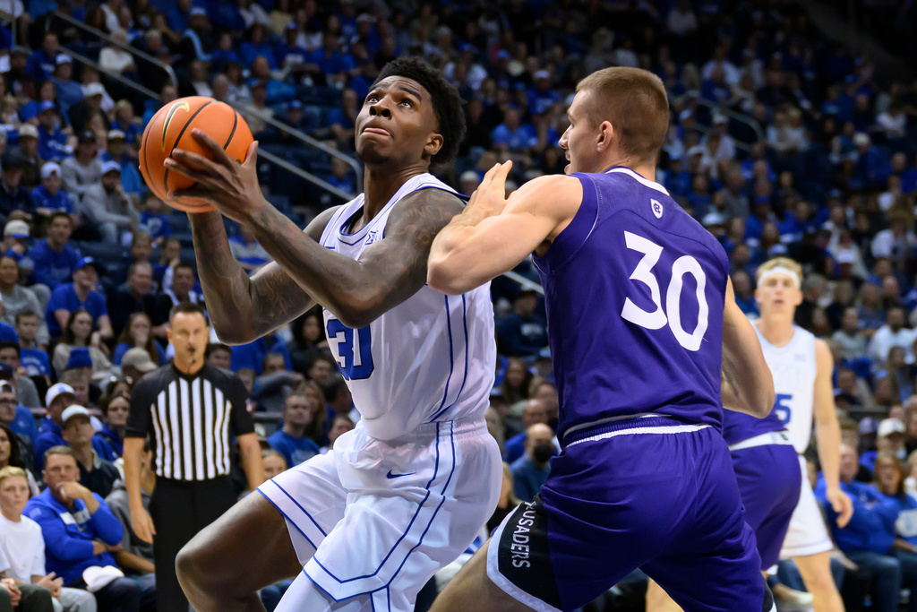 BYU forward Kennard Davis Jr. drives to the basket guarded by Holy Cross guard Joe Nugent (30) during the first half of an NCAA college basketball game, Saturday, Nov. 8, 2025, in Provo, Utah. (AP Photo/Tyler Tate)