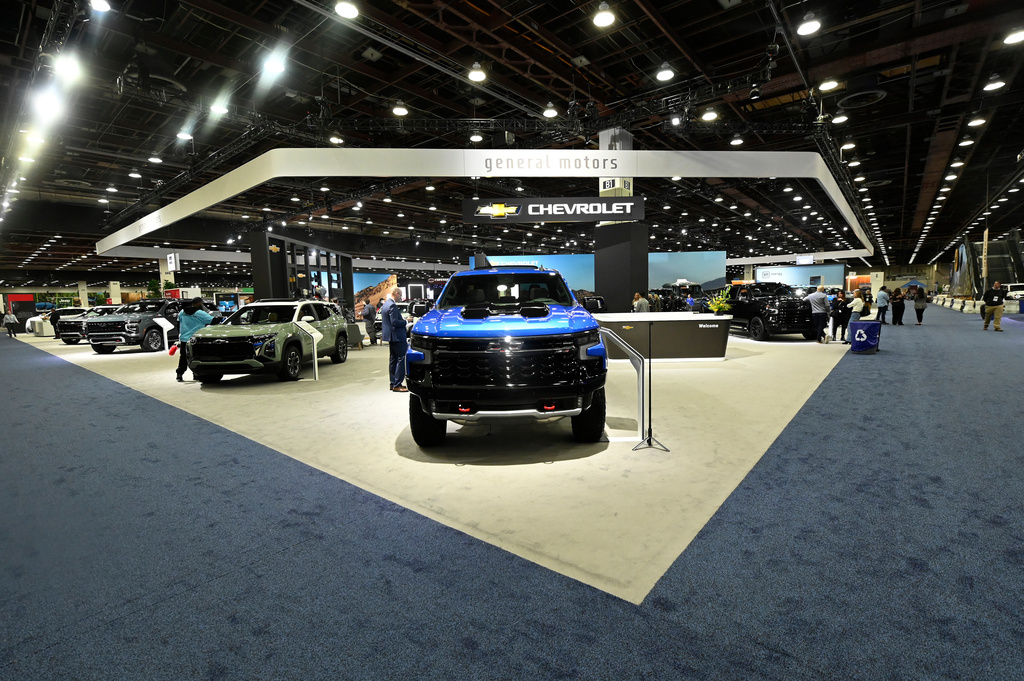 FILE - The General Motors display is seen, which includes a 2025 Silverado ZR2, foreground, at the Detroit Auto Show, Friday, Jan. 10, 2025, in Detroit. (AP Photo/Jose Juarez, file)