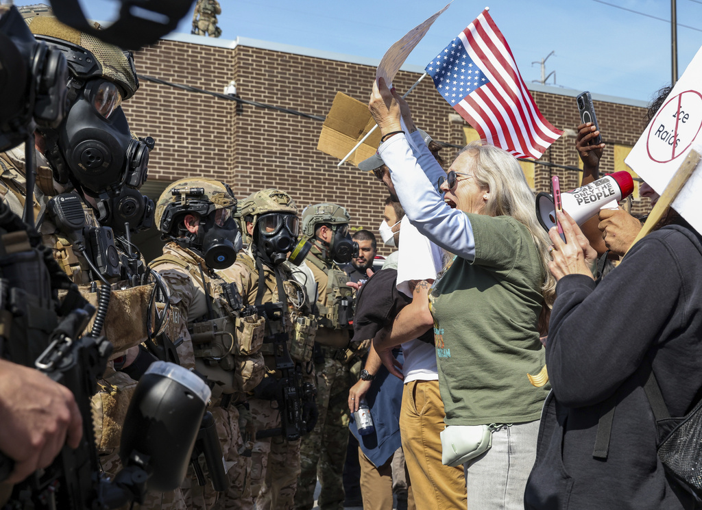 Protester Sherry yells at federal agents while standing face to face with them as the agents cleared a path for their vehicles to enter and exit the Immigration and Customs Enforcement facility in Broadview on Friday, Sept. 12, 2025. (Dominic Di Palermo/Chicago Tribune via AP)