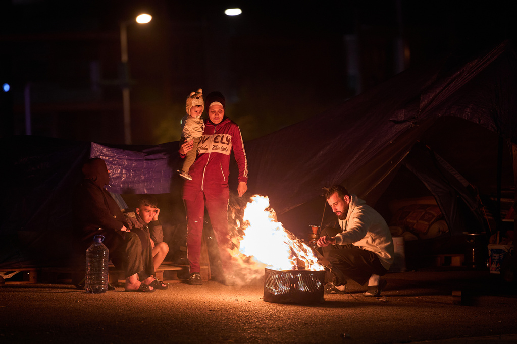 A displaced family, who fled Israeli bombings in southern Lebanon, make a bonfire next to a tent used as a shelter in Beirut, Lebanon, Friday, April 4, 2026. (AP Photo/Emilio Morenatti)