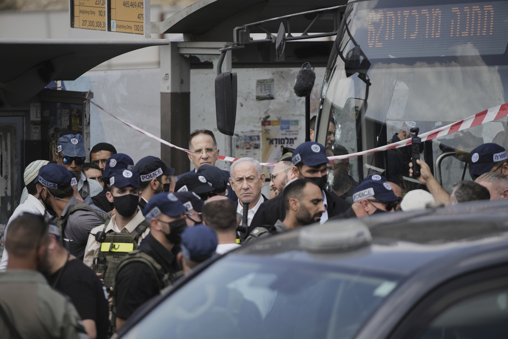 Israeli Prime Minister Benjamin Netanyahu visits the site of a shooting attack carried out by two Palestinian gunmen, in which several people were killed and others injured at a bus stop in Jerusalem, Monday, Sept. 8, 2025. (AP Photo/Mahmoud Illean)