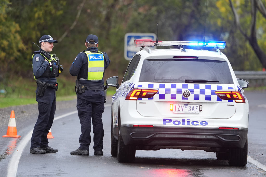 FILE - Police man a road block in Porepunkah, in the state of Victoria, Australia, on Aug. 28, 2025. (Simon Dallinger/AAP Image via AP, File)