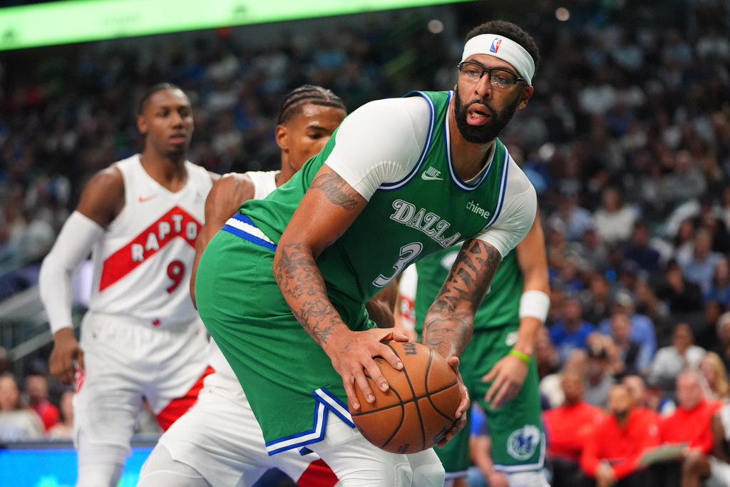 Dallas Mavericks forward Anthony Davis controls the ball during the first half of an NBA basketball game against the Toronto Raptors in Dallas, Sunday, Oct. 26, 2025. (AP Photo/LM Otero)