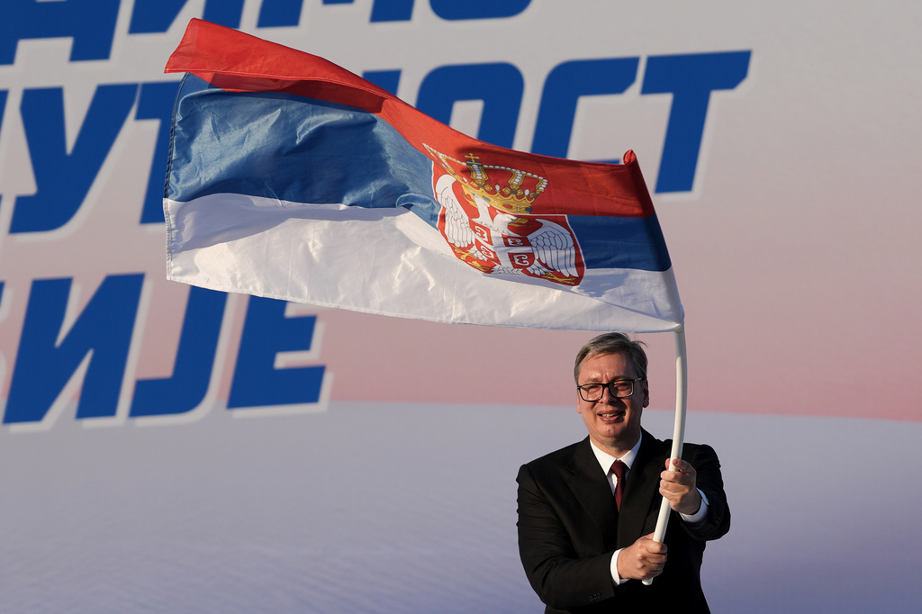 FILE - Serbian President Aleksandar Vucic waves a Serbian flag during a rally of the ruling Serbian Progressive Party (SNS) in Belgrade, Serbia, on June 27, 2026. (AP Photo/Darko Vojinovic, File)