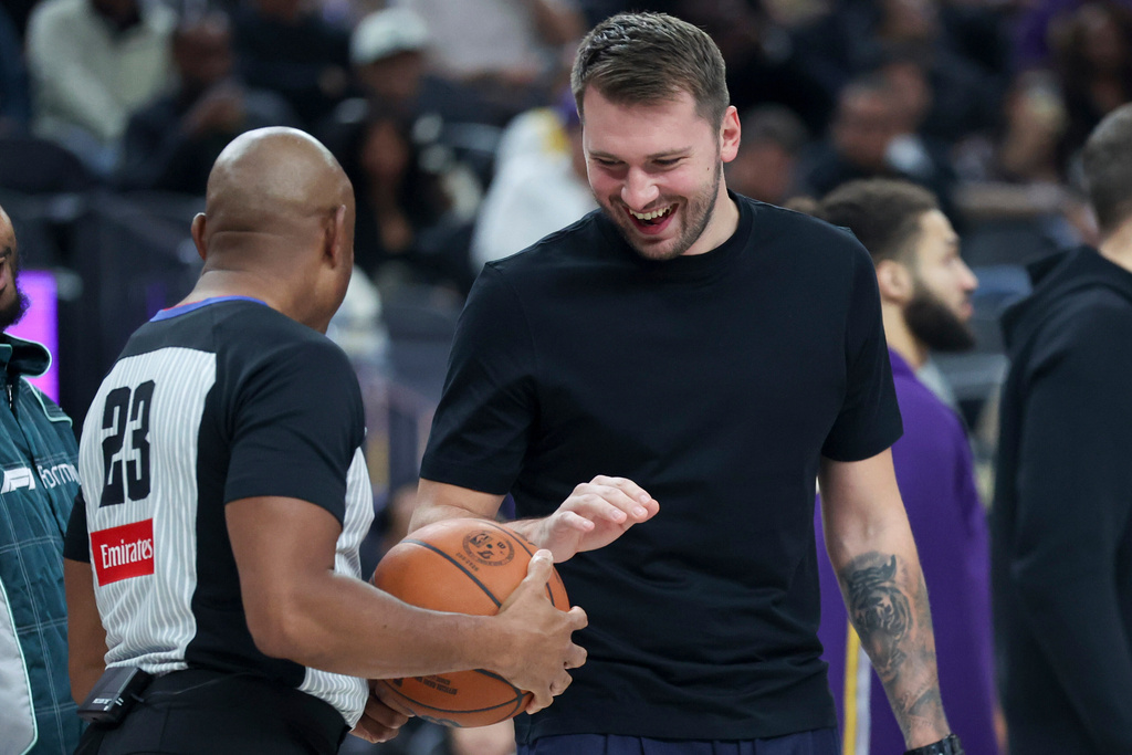 Los Angeles Lakers' Luka Doncic, right, talks to referee Tre Maddox (23) during the first half of a preseason NBA basketball game against the Dallas Mavericks Wednesday, Oct. 15, 2025, in Las Vegas. (AP Photo/Ian Maule)