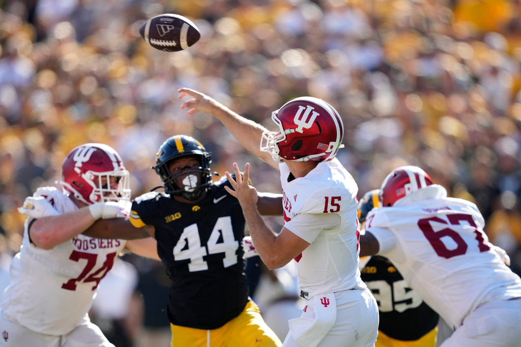Indiana quarterback Fernando Mendoza (15) throws a pass during the first half of an NCAA college football game against Iowa, Saturday, Sept. 27, 2025, in Iowa City, Iowa. (AP Photo/Charlie Neibergall)