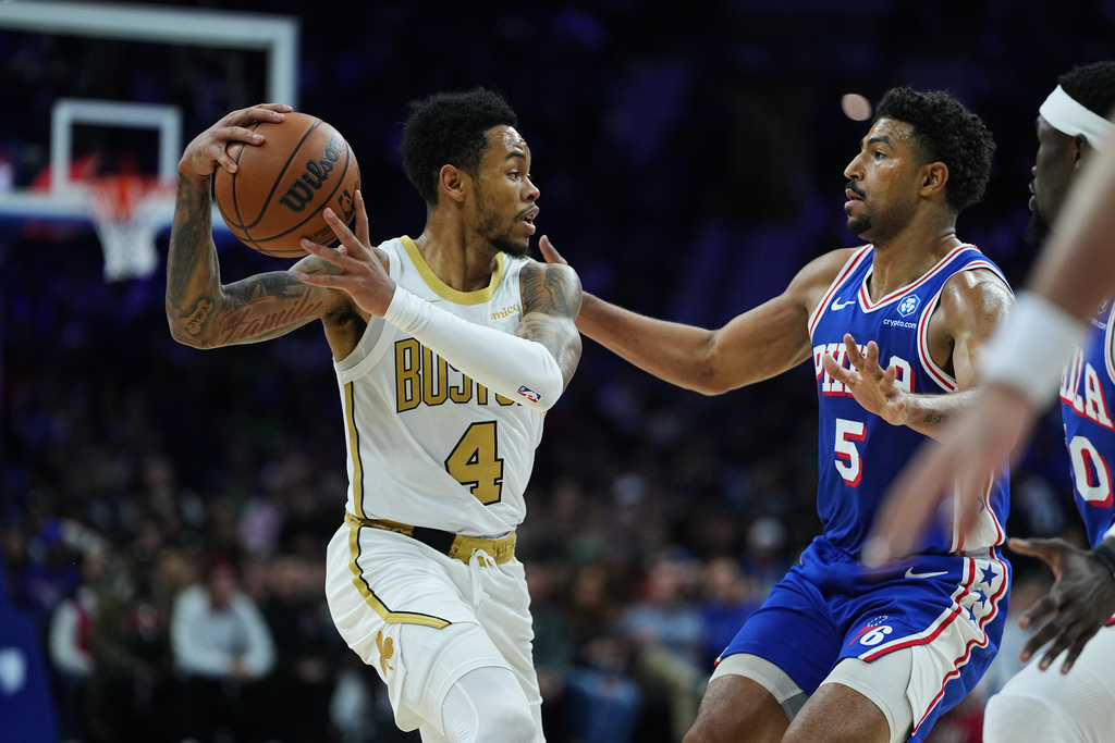 Boston Celtics' Anfernee Simons (4) looks to pass past Philadelphia 76ers' Quentin Grimes during the first half of an NBA basketball game Tuesday, Nov. 11, 2025, in Philadelphia. (AP Photo/Matt Rourke)