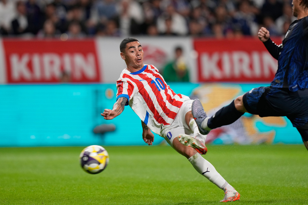 FILE - Paraguay's Miguel Almiron shoots to score as Japan's Koki Ogawa attempts to block during the friendly soccer match between Japan and Paraguay on Friday, Oct. 10, 2025, in Suita, Osaka, western Japan. (AP Photo/Eugene Hoshiko, File)