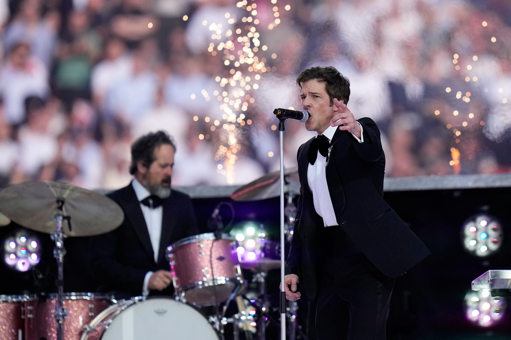 The Killers lead vocalist Brandon Flowers performs during the Champions League final soccer match between Paris Saint-Germain and Arsenal in Budapest, Hungary, Saturday, May 30, 2026. (AP Photo/Petr Josek)