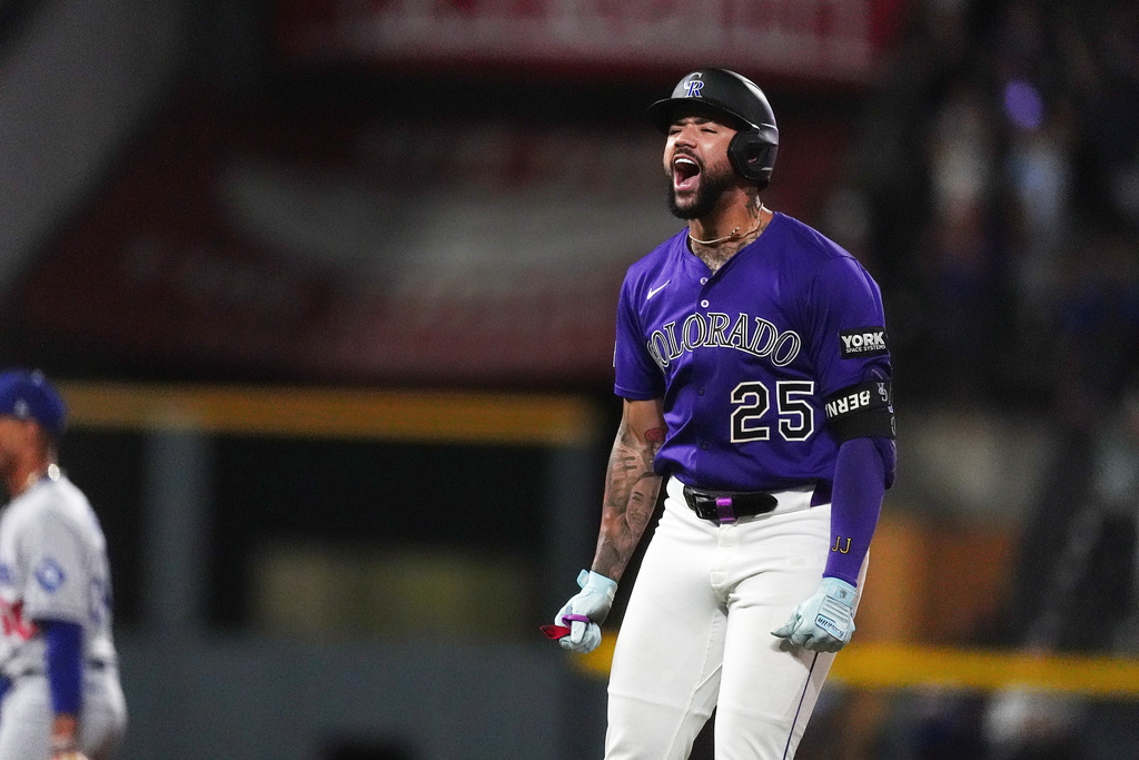 Colorado Rockies' Warming Bernabel celebrates after hitting a walk-off RBI single off Los Angeles Dodgers relief pitcher Justin Wrobleski in the ninth inning of a baseball game Monday, Aug. 18, 2025, in Denver. (AP Photo/David Zalubowski)