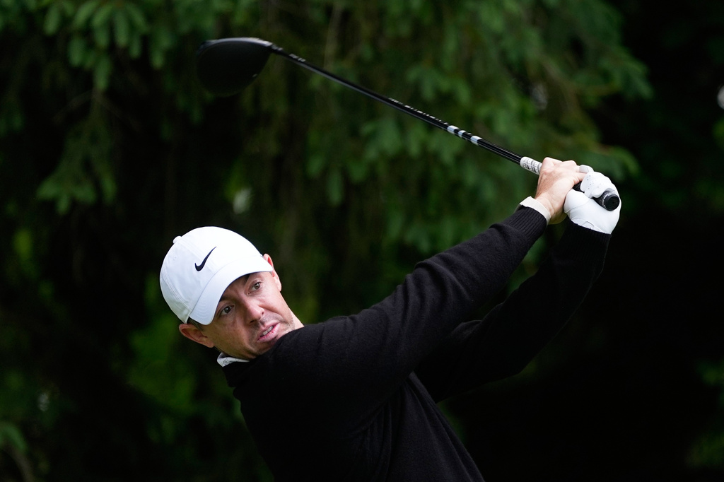 Rory McIlroy, of Northern Ireland, watches his tee shot on the fourth hole during the first round of the PGA Championship golf tournament practice round at Aronimink Golf Club, Thursday, May 14, 2026, in Newtown Square, PA. (AP Photo/Matt Slocum)