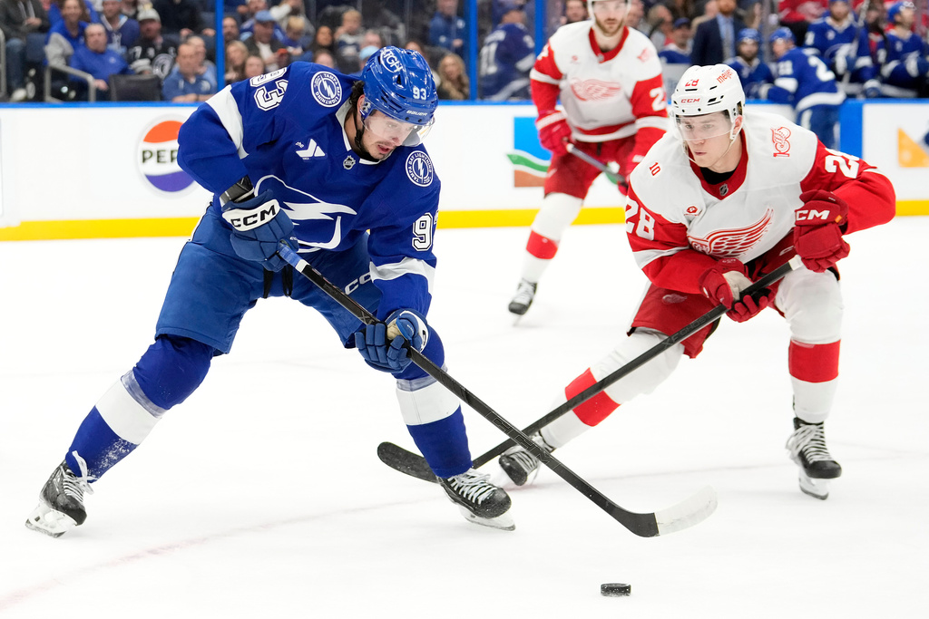 Tampa Bay Lightning center Gage Goncalves (93) chases the puck against Detroit Red Wings right wing Michael Brandsegg-Nygård (28) during the second period of an NHL hockey game Thursday, March 12, 2026, at Benchmark International Arena in Tampa, Fla. (AP Photo/Chris O'Meara)