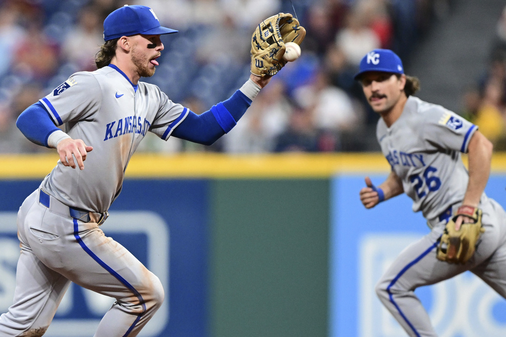 Kansas City Royals shortstop Bobby Witt Jr., left, fields a ball hit by Cleveland Guardians' C.J. Kayfus during the fourth inning of a baseball game, Wednesday, Sept. 10, 2025, in Cleveland. (AP Photo/David Dermer)
