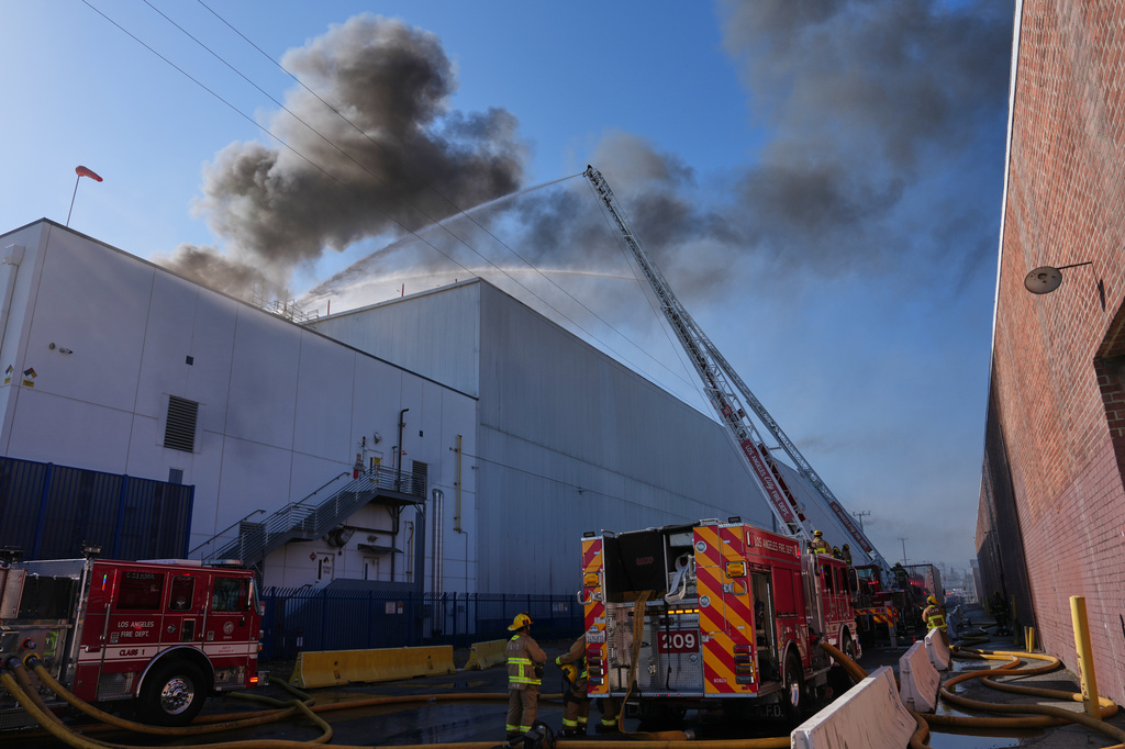 Crews work a warehouse fire in the Boyle Heights section of Los Angeles on Wednesday, June 17, 2026. (AP Photo/Jae C. Hong)