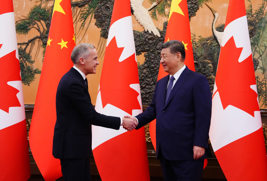 Canada's Prime Minister Mark Carney, left, meets with Chinese President Xi Jinping at the Great Hall of the People in Beijing Friday, Jan. 16, 2026. (Sean Kilpatrick/The Canadian Press via AP)