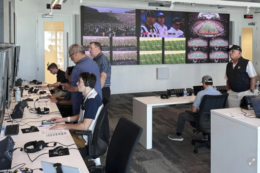 FILE - Alberto Riveron, second left, the Atlantic Coast Conference supervisor of football officials, works in the league's new gameday operations center, Saturday, Sept. 2, 2023, in Charlotte, N.C. (AP Photo/Aaron Beard, File) FILE - Alberto Riveron, second left, the Atlantic Coast Conference supervisor of football officials, works in the league's new gameday operations center, Saturday, Sept. 2, 2023, in Charlotte, N.C. (AP Photo/Aaron Beard, File)