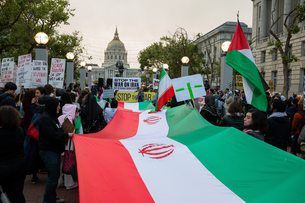 Protesters hold signs and chant antiwar slogans near Civic Center Plaza in San Francisco on Wednesday, April 8, 2026. (Dan Hernadez/San Francisco Chronicle via AP)