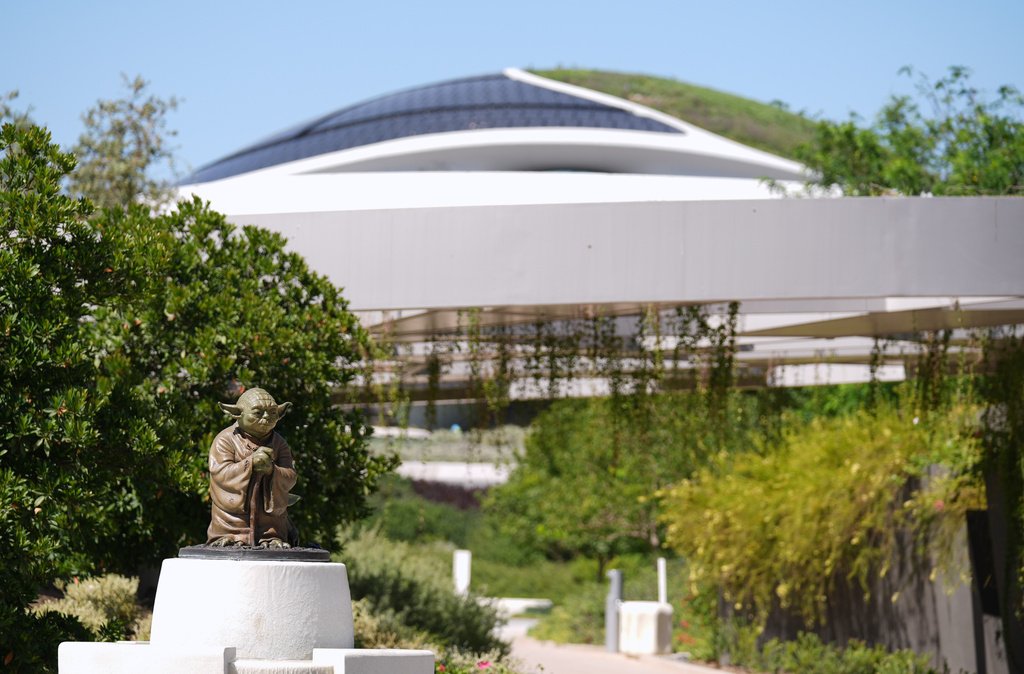 A sculpture of the "Star Wars" character Yoda is displayed along a walking path in the garden area of the the Lucas Museum of Narrative Art during a preview of the museum on Monday, Aug. 31, 2026, in Los Angeles. (AP Photo/Chris Pizzello)