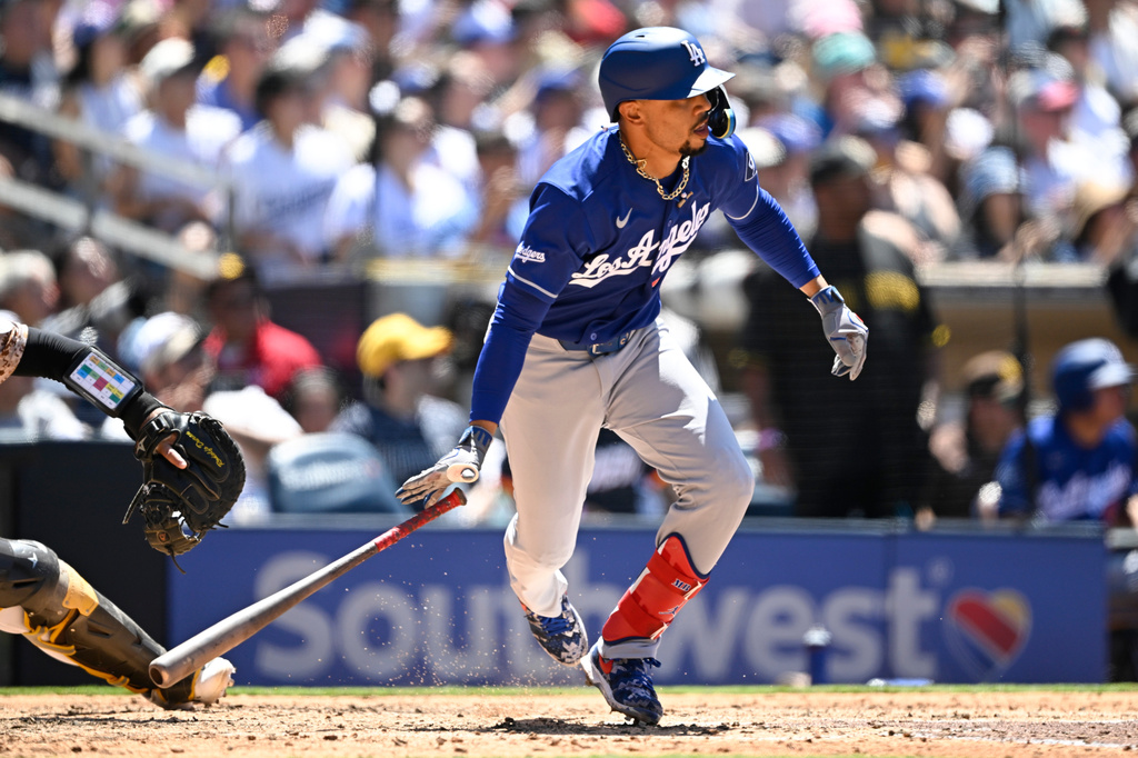 Los Angeles Dodgers' Mookie Betts watches his RBI single during the fifth inning of a baseball game against the San Diego Padres, Sunday, June 28, 2026, in San Diego. (AP Photo/Denis Poroy)