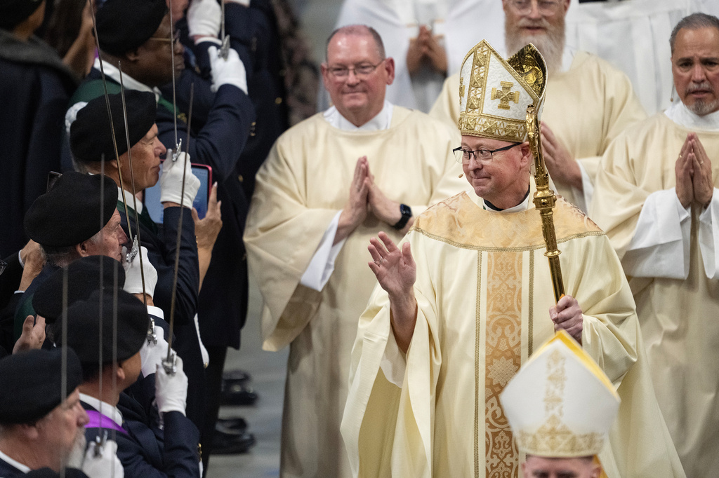 FILE - Archbishop James R. Golka blesses members of the congregations during the recessional procession at the end of the Mass of Installation for Golka as the sixth Archbishop of Denver, March 25, 2026, at the CoBank Arena at the National Western Center in Denver. (Timothy Hurst/The Denver Post via AP, File)