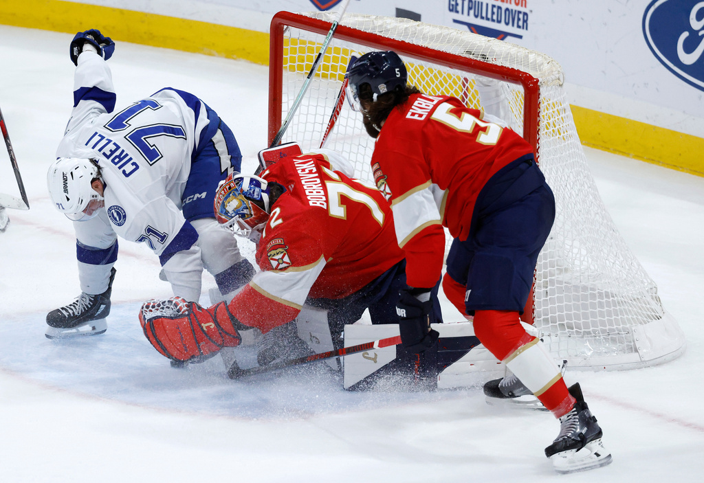 Florida Panthers goaltender Sergei Bobrovsky (72) and defenseman Aaron Ekblad (5) defend the goal against Tampa Bay Lightning center Anthony Cirelli (71) during the first period of an NHL hockey game Saturday, Dec. 27, 2025, in Sunrise, Fla. (AP Photo/Rhona Wise)