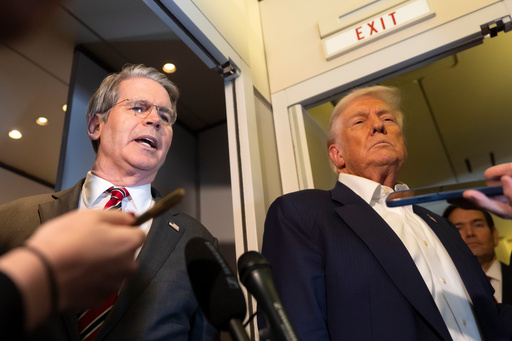 Treasury Secretary Scott Bessent, left, speaks to reporters as President Donald Trump, right, listens aboard Air Force One while traveling from Kuala Lumpur, Malaysia, to Tokyo, Japan, Monday, Oct. 27, 2025. (AP Photo/Mark Schiefelbein) Treasury Secretary Scott Bessent, left, speaks to reporters as President Donald Trump, right, listens aboard Air Force One while traveling from Kuala Lumpur, Malaysia, to Tokyo, Japan, Monday, Oct. 27, 2025. (AP Photo/Mark Schiefelbein)