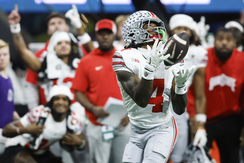 FILE - FILE - Ohio State wide receiver Jeremiah Smith catches a pass during second half of the College Football Playoff national championship game against Notre Dame, Monday, Jan. 20, 2025, in Atlanta. (AP Photo/Butch Dill, File)
