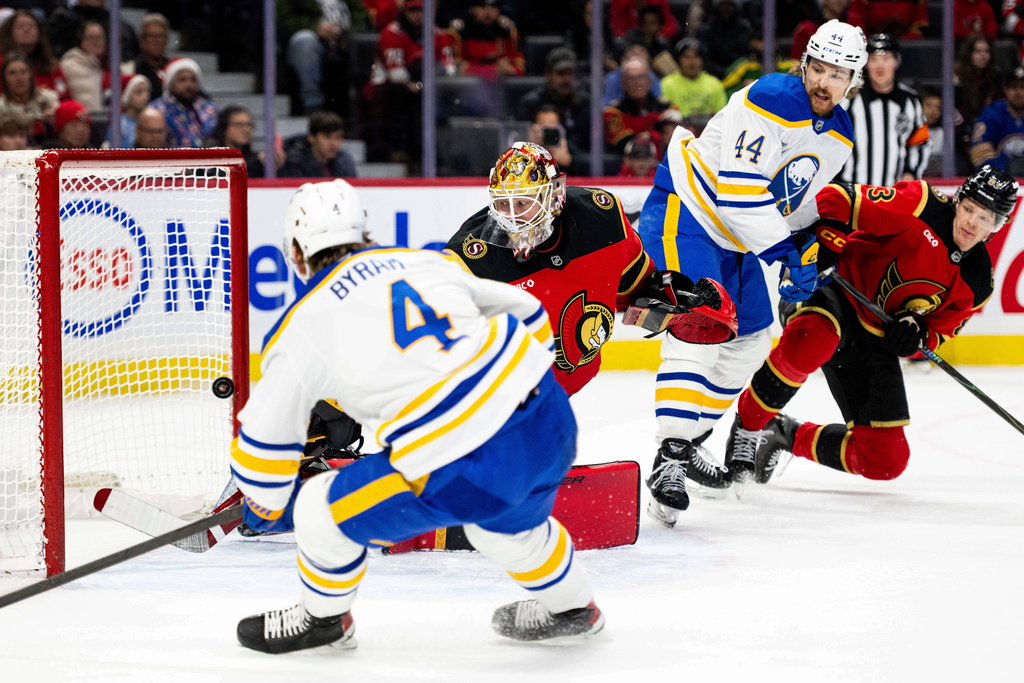 Buffalo Sabres' Bowen Byram (4) scores on Ottawa Senators goaltender Linus Ullmark (35) during first period NHL hockey action in Ottawa, on Tuesday, Dec. 23, 2025. (Spencer Colby/The Canadian Press via AP)