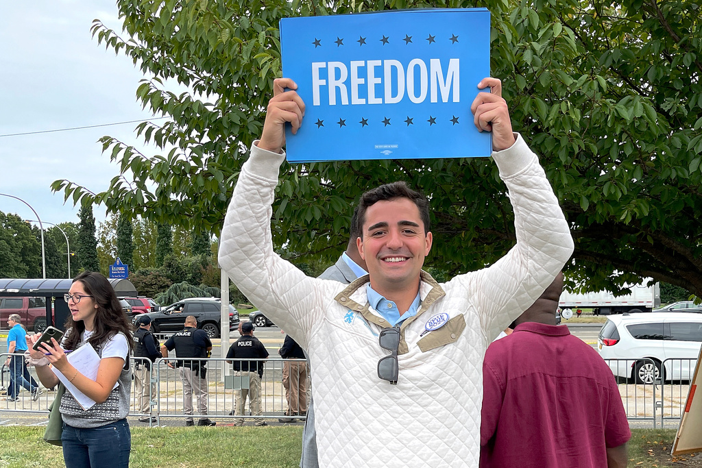Petros Krommidas holds up a sign during an anti-Trump rally at Nassau Coliseum, Wednesday, Sept. 18, 2024, in Uniondale, N.Y. (Mark DeFrancesco via AP)