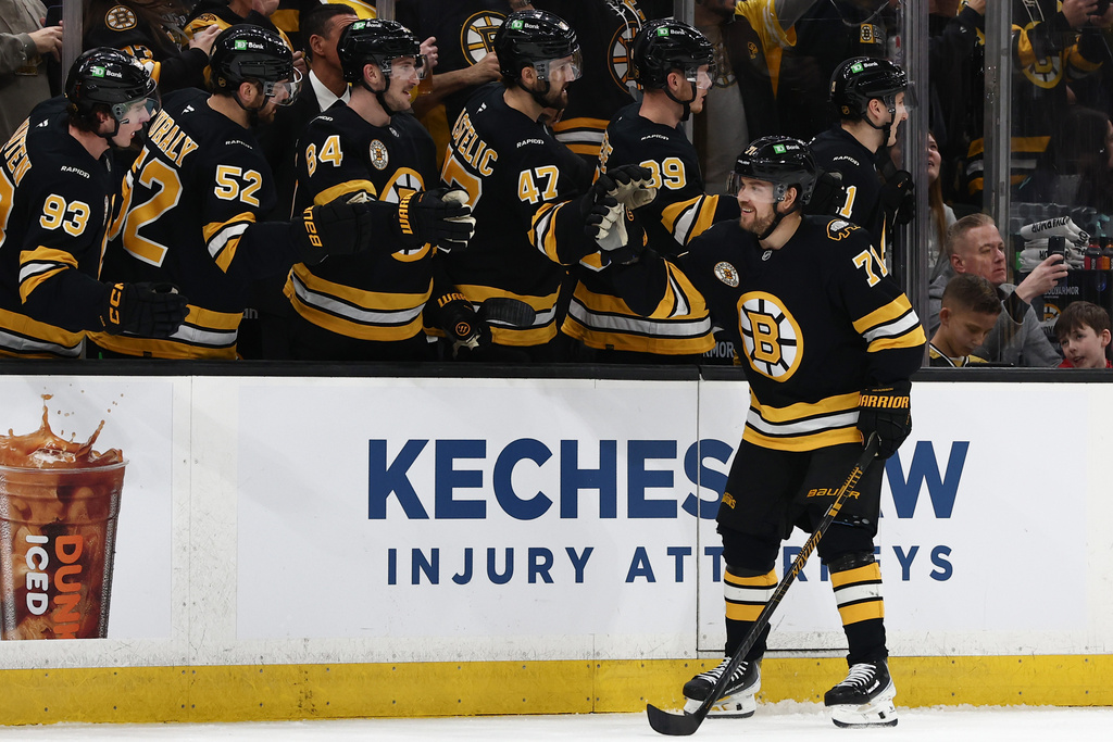 Boston Bruins' Viktor Arvidsson is congratulated at the bench after scoring against the Seattle Kraken during the first period of an NHL hockey game Thursday, Jan. 15, 2026, in Boston. (AP Photo/Winslow Townson)